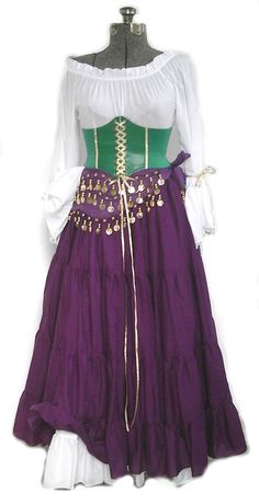 a woman's purple and green dress with gold trimmings on the waist