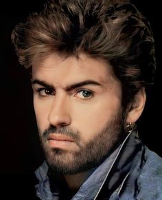 a close up of a person with a beard and piercings on his head, looking at the camera