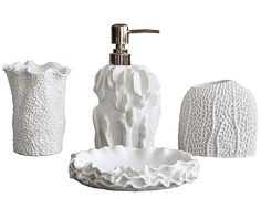 three white bathroom accessories including soap dispenser, soap dish and toothbrush holder