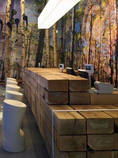 there are many stacks of wood in the store that is decorated with trees and birds