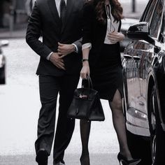 a man and woman walking down the street