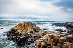 there is a large rock formation on the shore near the ocean with words over it that read 11 - day itinery for ireland and northern ireland