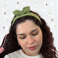 a woman wearing a green crochet headband with a bow on it's side