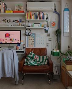 a living room filled with furniture and a flat screen tv mounted to the side of a wall