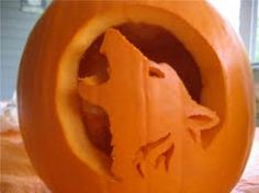 a carved pumpkin with a bear on it