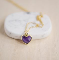 Give yourself some love or show your love for that special someone in your life with this heart necklace!Amethyst is believed to carry the energies of passion, creativity, and spirituality. It's also said to assist with temperance and sobriety, as well as inflammation.This necklace is handcrafted with a purple Amethyst faceted heart pendant. Each stone is natural and therefore contains natural inclusions or crystal formations. They are edged in 24k gold or silver electroplate. STONE SIZE: averag Purple Heart Necklace With Heart Charm As A Gift, Purple Heart Pendant Necklace As Gift, Purple Heart Charm Necklace For Gift, Spiritual Necklace With Heart Charm, Heart Pendant Amethyst Necklace For Gift, Heart-shaped Amethyst Necklaces As Gifts, Amethyst Heart Pendant Necklace For Gifts, Heart-shaped Amethyst Necklace For Gifts, Heart-shaped Amethyst Necklace For Valentine's Day