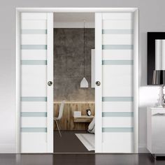 an open door in a room with white walls and blue stripes on the doors,