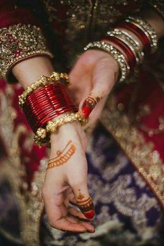 a woman in red and gold holding her hands