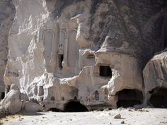 the rock formations are carved into the side of the mountain with small holes in them