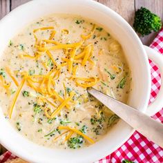 a white bowl filled with broccoli cheese soup