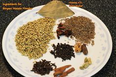 an assortment of spices on a white and blue plate