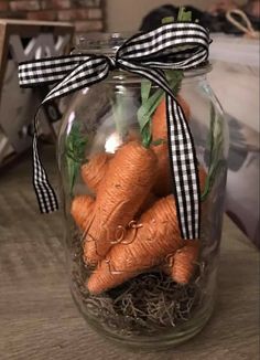 a jar filled with carrots sitting on top of a table