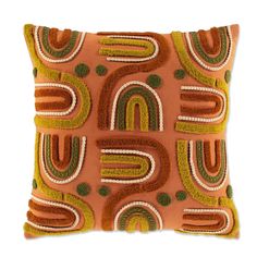 an orange and green decorative pillow on a white background