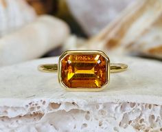 This beautiful ring contains a natural 2.00 ct. emerald cut yellow citrine. The ring is available in sterling silver, and 14K white, yellow or rose gold. The mounting is a modern, high polish, heavyweight setting. The center stone measures 8x6mm. This ring makes a great gift for a birthday, Mother's Day, bridesmaids, or any other special occasion. Yellow Citrine is the birthstone for November. Please send me a message if you need a size not listed. This ring can be customized with any color cent Yellow Gold Citrine Topaz Ring, Emerald Cut, Faceted Emerald Cut Topaz Fine Jewelry Ring, Citrine Gemstone Rings In Baguette Cut, Faceted Emerald Cut Topaz Ring In Fine Jewelry, Emerald Cut Faceted Topaz Ring In Fine Jewelry Style, Emerald Cut Yellow Gold Topaz Ring, Emerald Cut Topaz Ring In Yellow Gold, Octagon Citrine Gemstone Ring, Emerald Cut Yellow Gold Topaz Ring With Bezel Setting