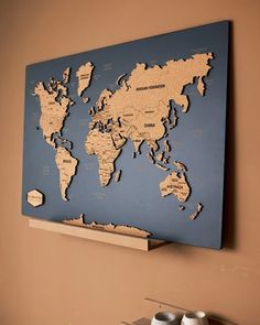 a wooden world map hanging on the wall