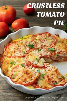 a casserole dish with tomatoes and cheese on the side, ready to be eaten