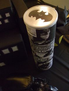 a batman coffee cup sitting on top of a table