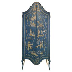 an ornate blue and gold painted armoire