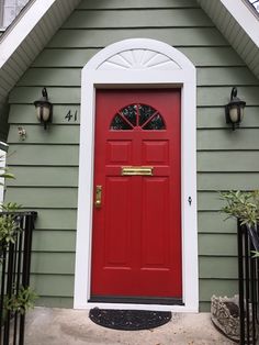 a red front door on a green house