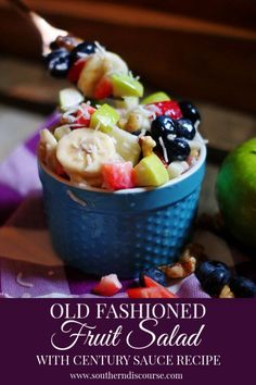 an old fashioned fruit salad is served in a blue bowl and garnished with fresh fruit