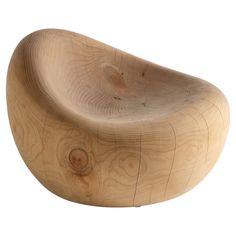 a wooden chair that is shaped like a curved object with wood grain on the sides