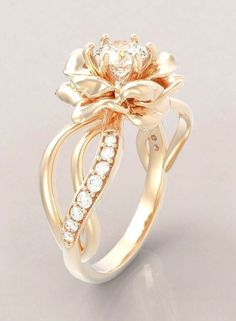 a gold ring with flowers and diamonds on it