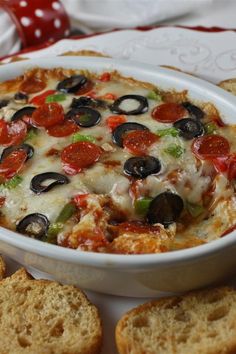 a pizza dip with olives, pepperoni and cheese