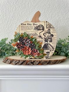 a wooden pumpkin sitting on top of a mantle