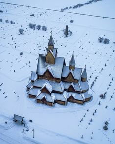 an aerial view of a large church in the middle of winter with snow on the ground