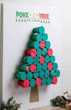 a christmas tree made out of green, red and pink circles on a white wall