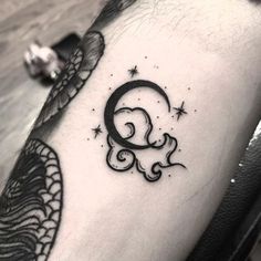 a black and white tattoo with the letter q on it's left arm, next to a dragon