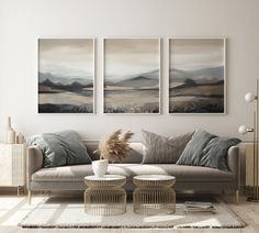 a living room with three paintings on the wall