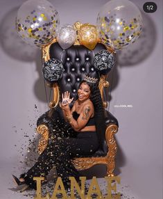 a woman sitting on top of a chair with balloons and confetti around her