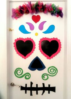 a white door decorated with colorful sugar skulls