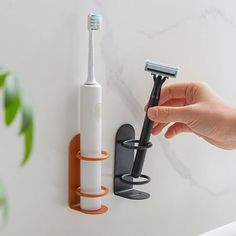 Description: Introducing our versatile and convenient wall-mounted electric toothbrush holder! Designed to fit a variety of surfaces such as tile, glass, marble, and wood, this toothbrush holder effectively prevents water and dust from entering the wall. Installation is a breeze - simply peel off the tissue paper on the back and stick it wherever you desire, no drilling or tools required. With this stick-on toothbrush holder, you can easily access your toothbrush and take out your electric tooth Bathroom Toothbrush Organization, Bathroom Toothbrush Storage, Tooth Brush Holder, Wall Mounted Toothbrush Holder, Toothbrush Organization, Electric Toothbrush Holder, Vintage Bathroom Decor, Toothbrush Holder Wall, Modern Bathroom Accessories