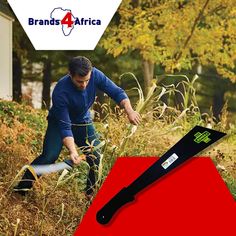 a man is cutting grass with a large knife on top of the red board in front of him