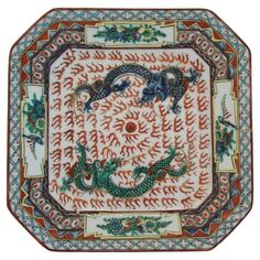 an intricately decorated plate with dragon designs