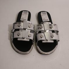 Nwt Womens Dkny Glynn Silver Chrome Leather Flat Sandals 6 * Retail: $110 Size: 6 Color: Silver Slip-On Flat Stud Detail Material: Leather Measurements (Flat): Length Heel- Toe: 9.6" Width: 3.6" New With Tags. (Bag/Z) Sondr- 4** Modern Silver Sandals With Buckle Closure, Trendy Silver Sandals With Buckle Closure, Modern Silver Sandals For Night Out, Trendy Silver Flat Sandals, Silver Open Toe Sandals With Silver Studs, Silver Studded Open Toe Sandals, Chic Silver Flat Sandals, Designer Silver Sandals For Night Out, Dkny Shoes