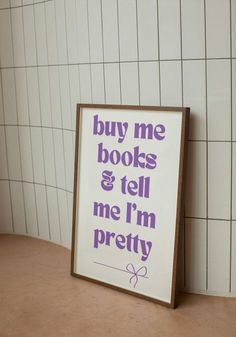 a sign that says buy me books and tell me i'm pretty