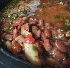 beans and onions are being cooked in a pot