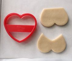 two cookie cutters and a heart shaped cookie