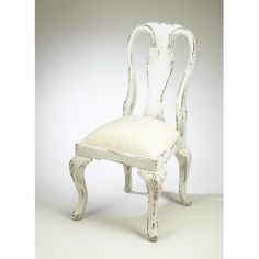 an old white chair with a cushion on it's back and seat upholstered