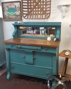 an old dresser painted teal with wood top