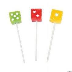 three different colored lollipops sitting on top of each other