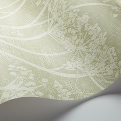 an abstract background with white flowers and leaves on green, beige and gray colors in the center