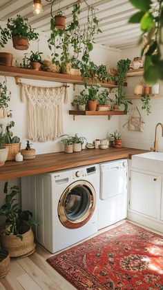 Boho-inspired laundry room featuring vibrant decor and stylish storage solutions. Plant Laundry Room, Boho House Inspo, Boho House Aesthetic, House Design Boho, Boho Laundry Room Ideas, Bohemian Laundry Room, Boho Laundry Room, Boho House Interior, Boho Laundry