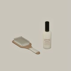 a wooden brush next to a bottle of lotion