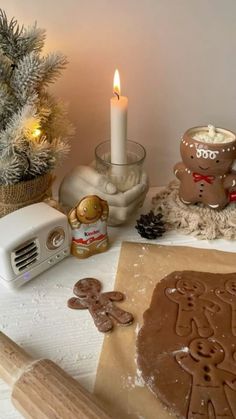 there is a cookie on the table next to a candle and some cookies in front of it