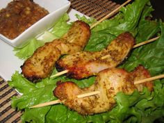 chicken skewers with lettuce and sauce on the side