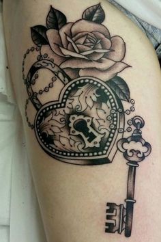 a tattoo with a key and rose on it